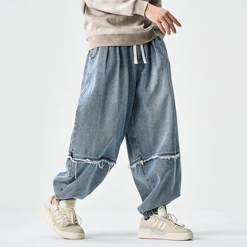 Herren Weit geschnittene Baggy-Denim-Hose mit Tunnelzug, elastischen Beinabschlüssen und Fransen-Detail Drune